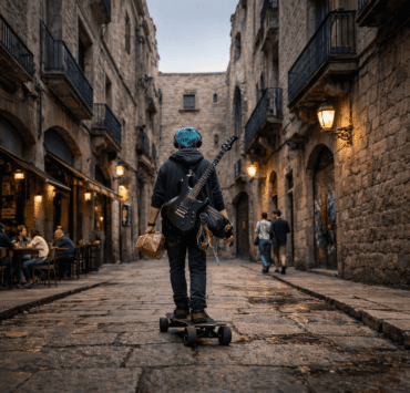 Simón en Barcelona: Imagen de un joven de 22 años con cabello azul turquesa, visto de espaldas mientras recorre en monopatín un callejón gótico del barrio del Born. Lleva una guitarra eléctrica negra colgada y audífonos, rodeado de fachadas de piedra y balcones de hierro.